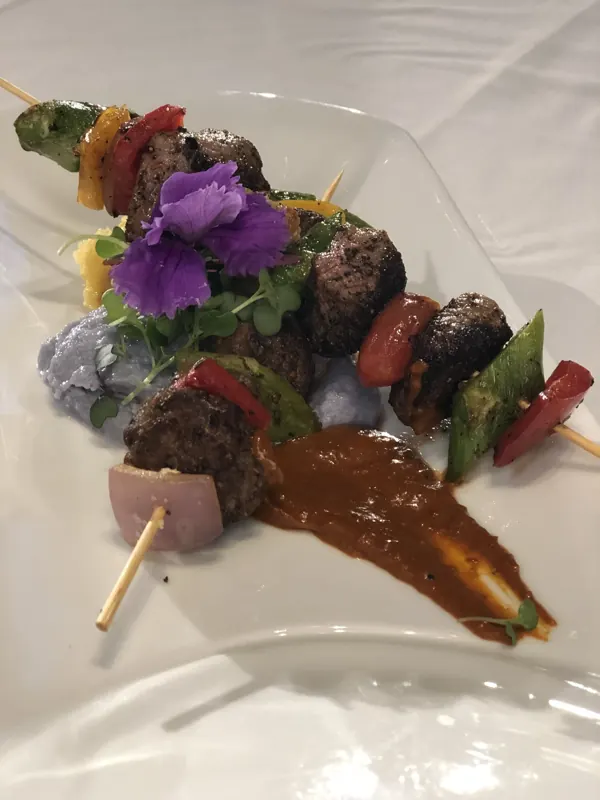 Lamb skewers with edible flowers